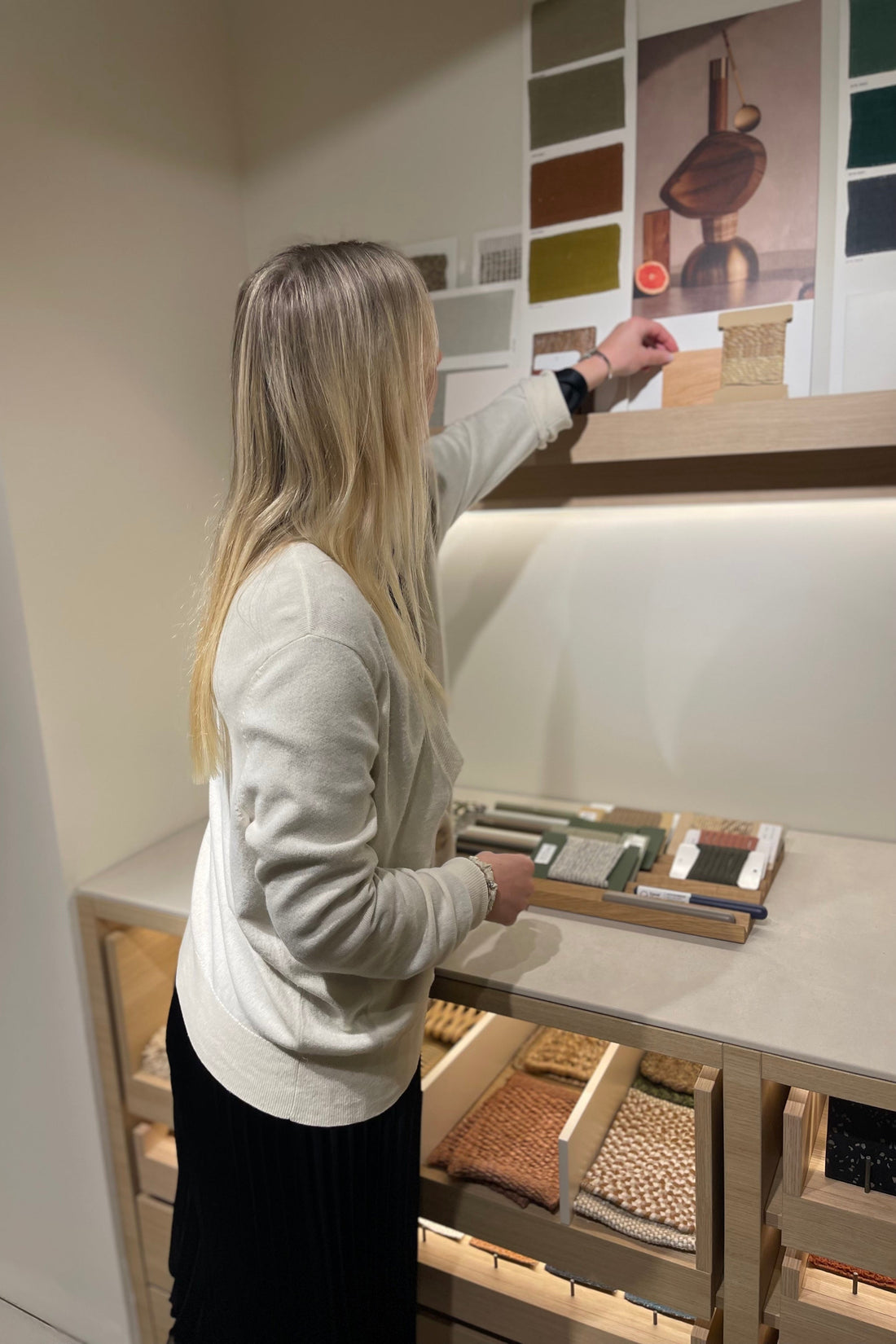 Interior designer reviewing fabric swatches for a colourful concept palette.