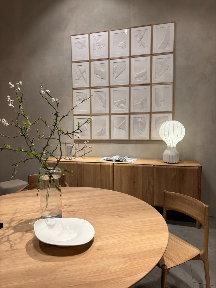 Light-toned dining room with minimalist Scandinavian inspired wood furniture.