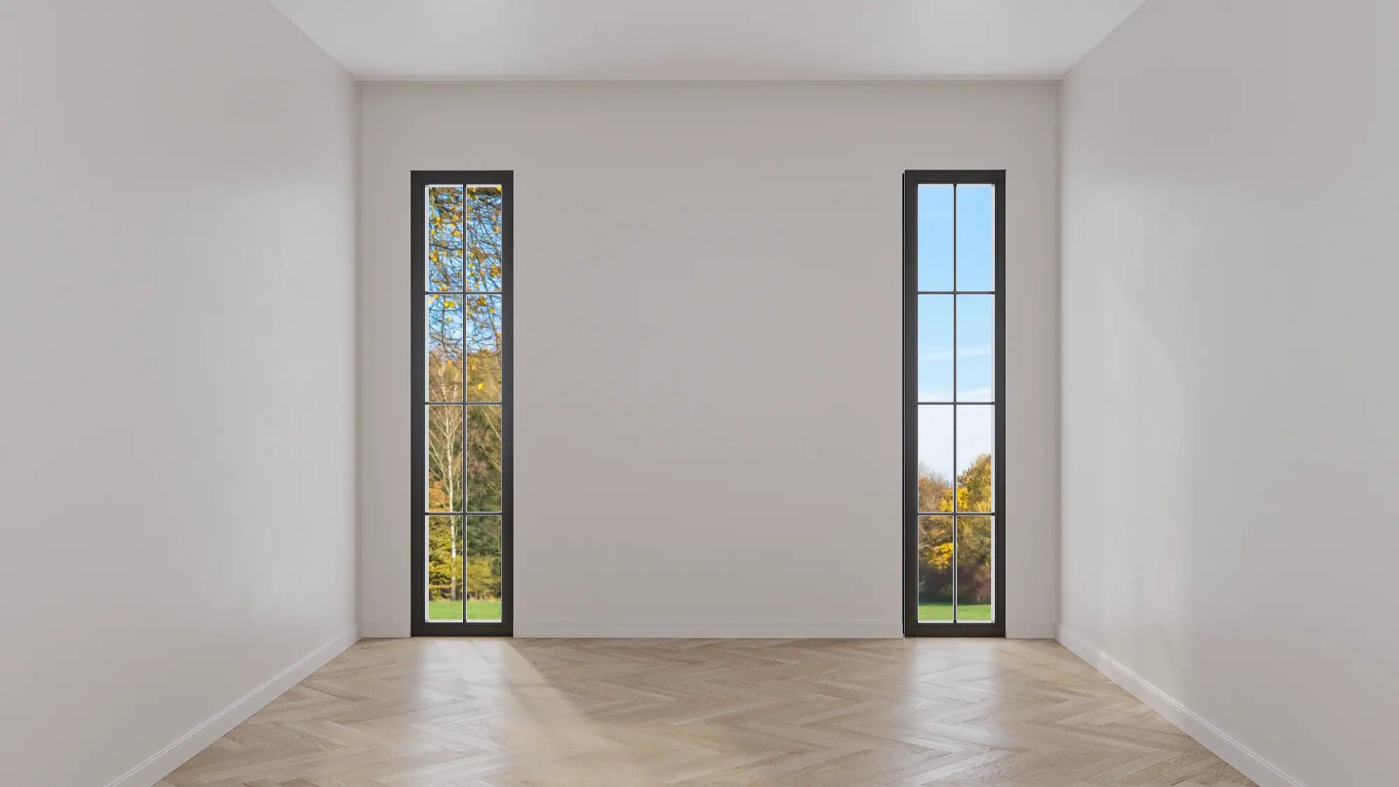 Before image of a room with white walls and herringbone wood flooring.