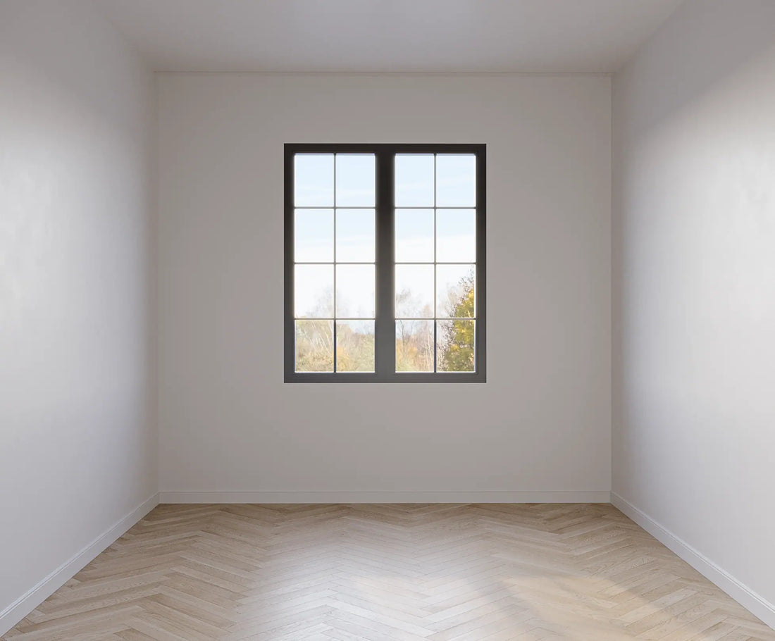 Before image of a 10 sqm room, herring bone flooring and white walls.