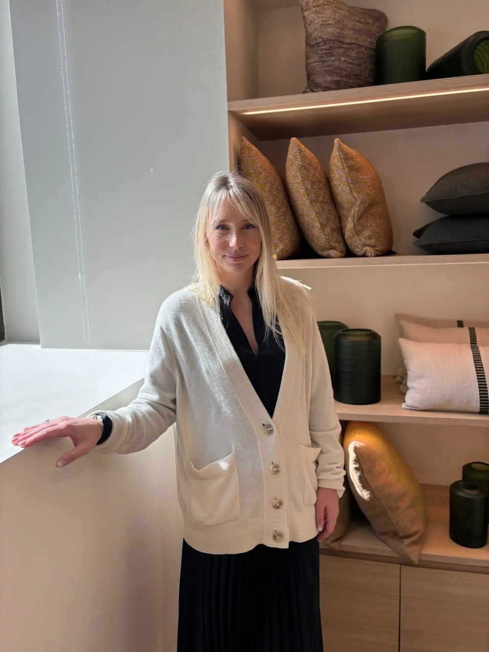 Founder of Formed & Furnished in a ochre and green interior.