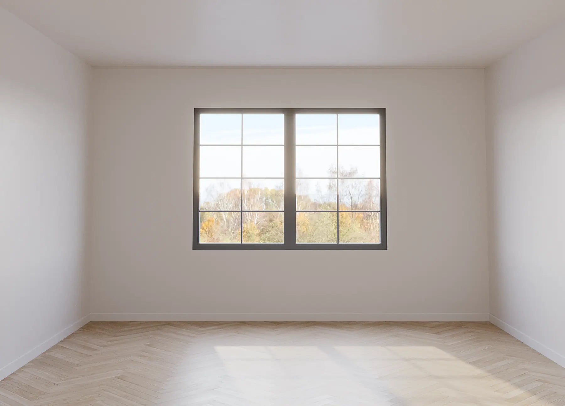 Before picture of a room with herringbone flooring and white walls.
