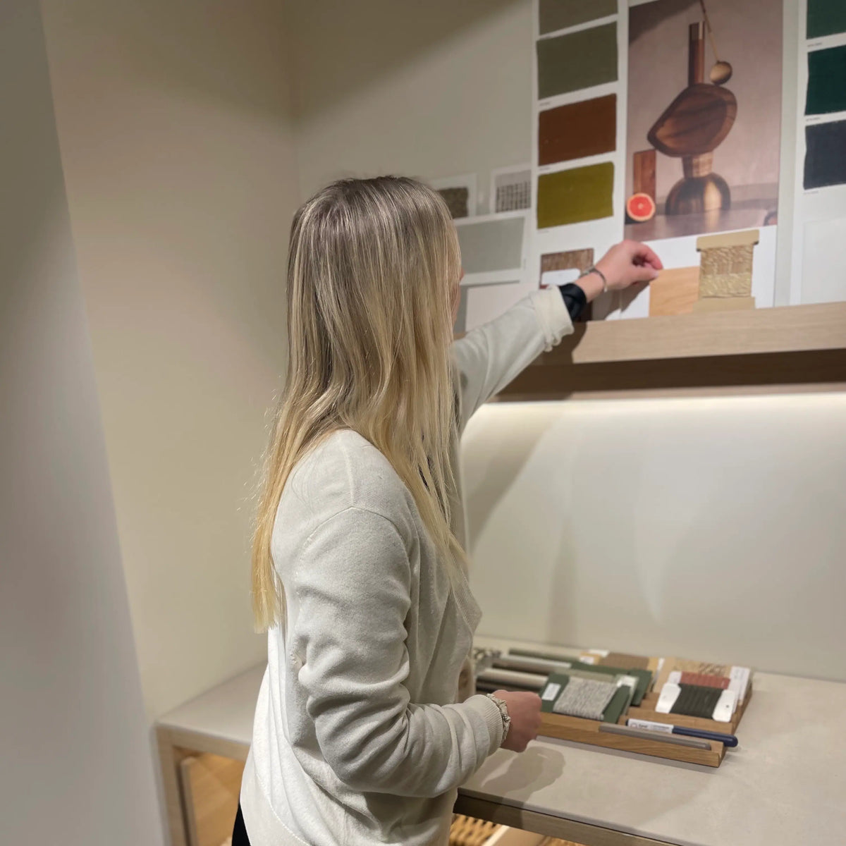 Interior designer reviewing fabric swatches for a colourful concept palette.