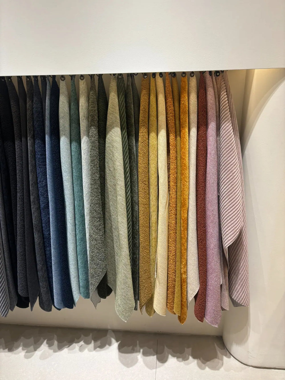 Organised fabric samples for a colourful Scandinavian inspired interior styling.