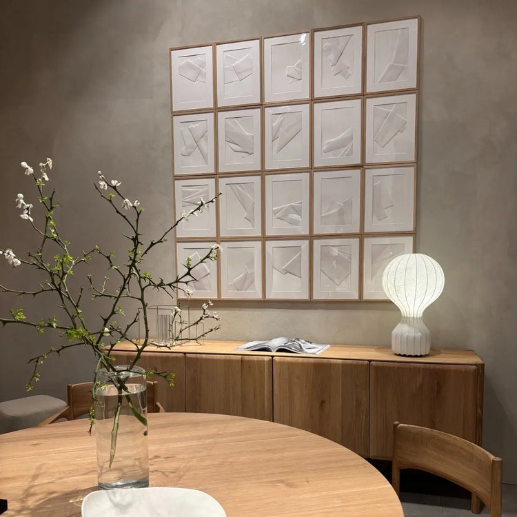 Light-toned Scandinavian inspired dining space with minimalist wooden furniture.